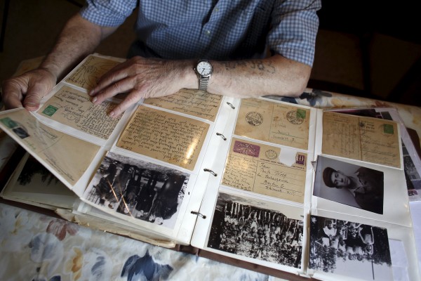 Holocaust survivor Israel Loewenstein, 91, looks at a photo album at his home in Yad Hana, Israel, April 6, 2016. REUTERS/ Nir Elias