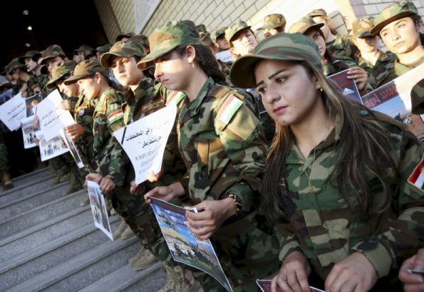 Displaced women from the minority Yazidi sect, who have joined the Kurdish peshmerga forces to fight against Islamic State militants, attend a ceremony in Dohuk, northern Iraq August 3, 2015. Masoud Barzani, president of Iraq's Kurdistan region, vowed on Monday to help the Yazidis return to their homes, after they fled from Islamic State last year. REUTERS/Ari Jalal