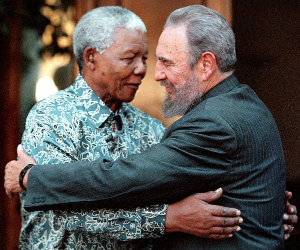 Former South African President Nelson Mandela (L) hugs Cuba's President Fidel Castro during a visit to Mandela's home in Houghton, Johannesburg in this September 2, 2001 file photo.  REUTERS/Chris Kotze/File Photo