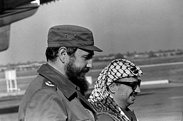Fidel Castro and PLO leader Yasser Arafat stand together at the airport in Havana during Arafat's first visit to Cuba November 14, 1974. REUTERS/Prensa Latina