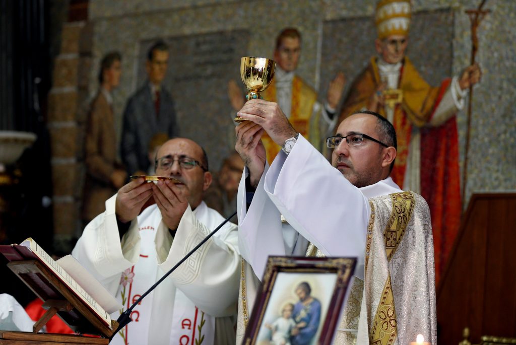 Christian priests conduct a mass at the Latin Patriarchate Church in ...